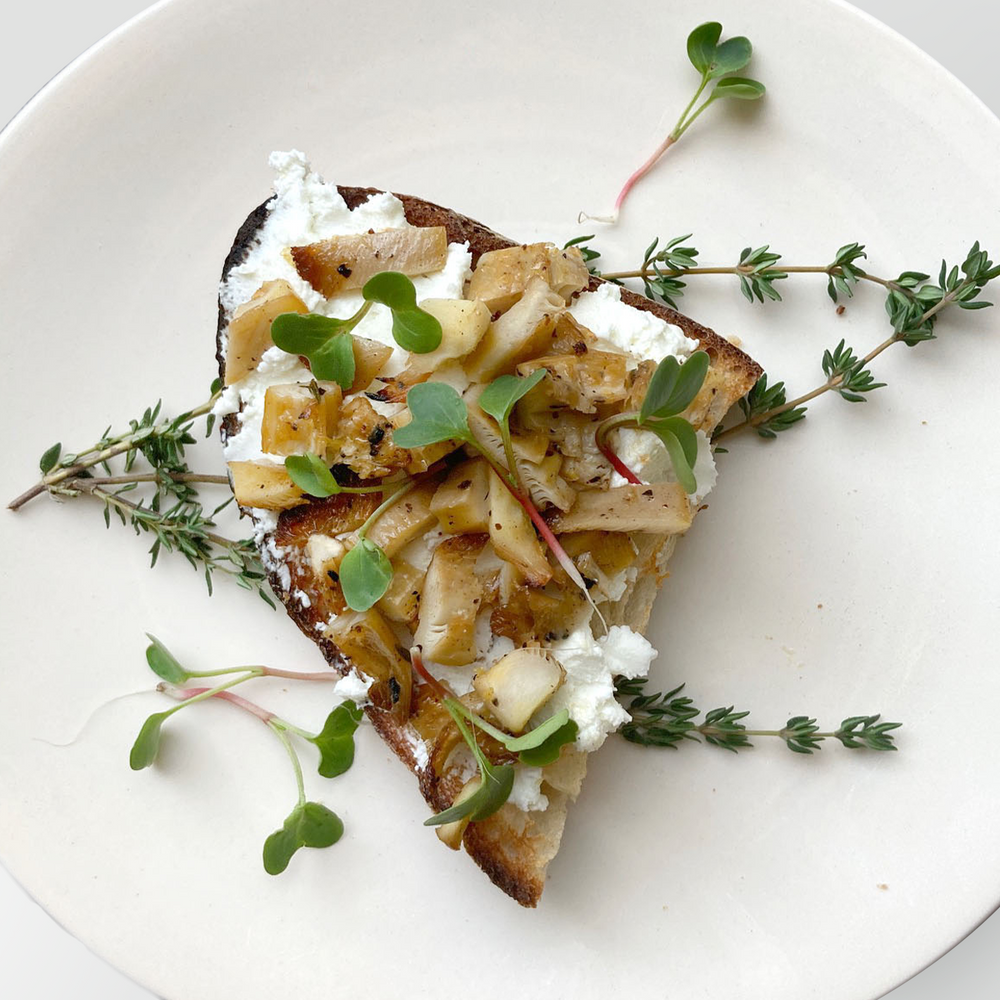 Marinated oyster mushrooms with goat cheese on sourdough toast