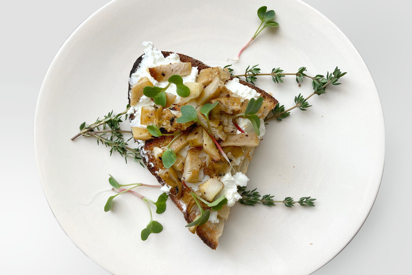 Marinated oyster mushrooms with goat cheese on sourdough toast